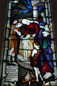 Detail of Dorcas in the chancel south window May 2010